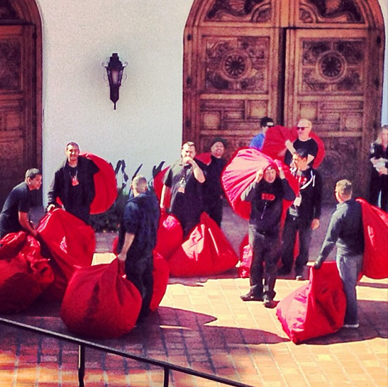 Red beanbags have always been a signature at TEDActive. Here, the crew loads up the theater before attendees arrive.